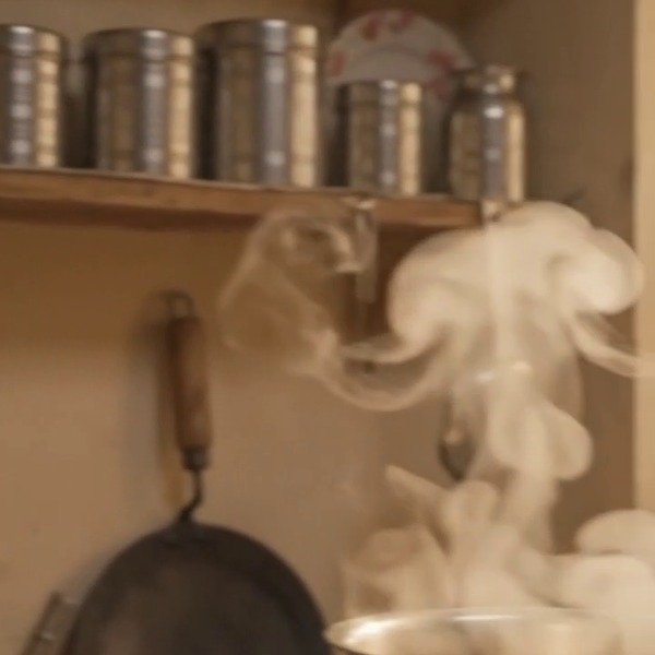 Hand-hammered brass degchi simmering over embers